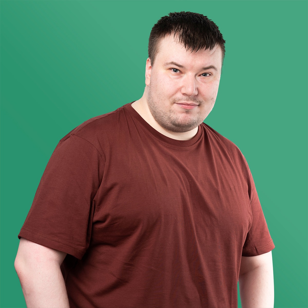 Man with brown hair wearing brown t-shirt facing the camera